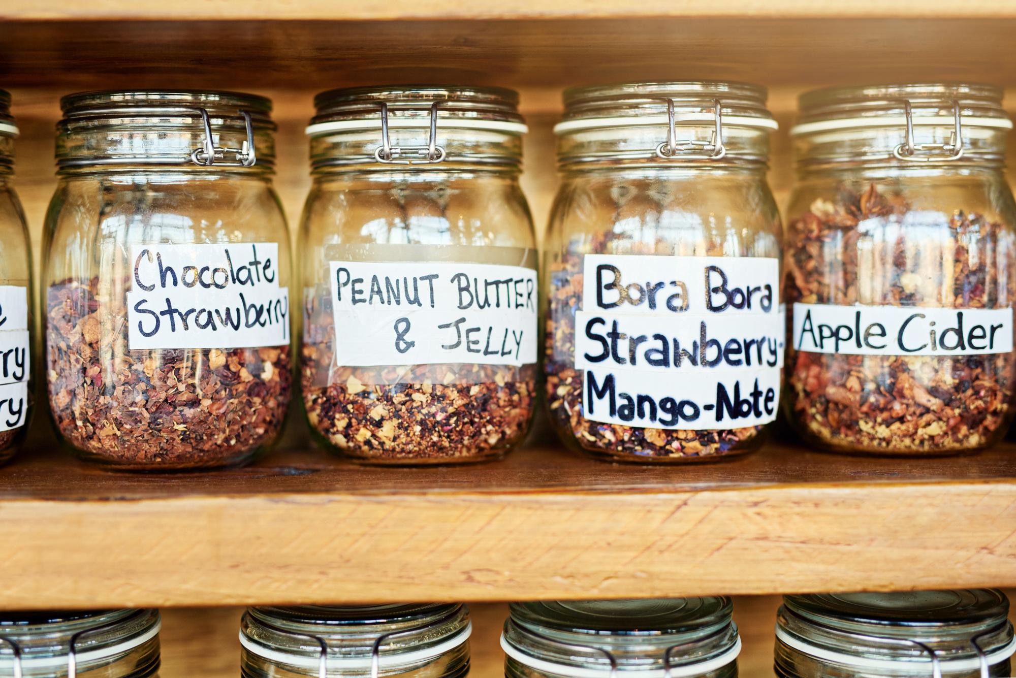 neatly labeled jars of pantry staples on shelf